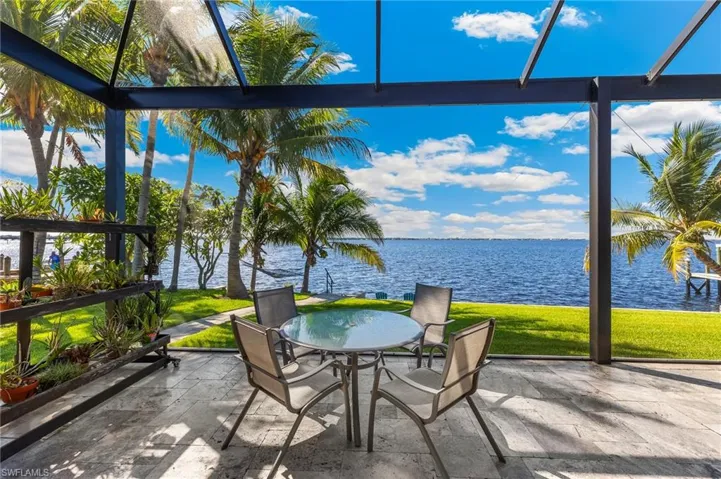 Sunroom featuring a water view