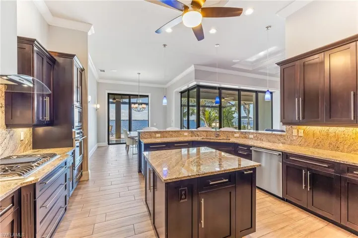 Kitchen featuring stainless steel appliances, a ceiling fan, backsplash, decorative light fixtures, and recessed lighting