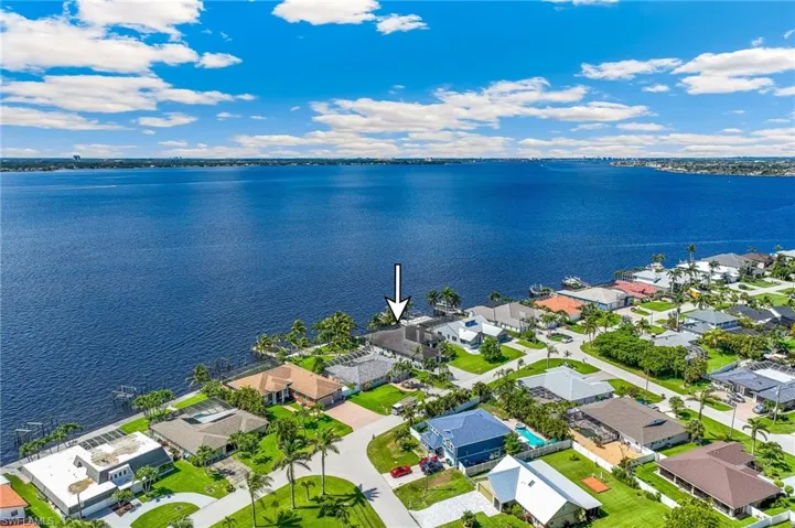 Aerial view of residential area featuring a nearby body of water