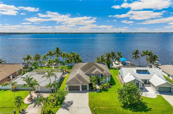 Aerial perspective of suburban area featuring a nearby body of water