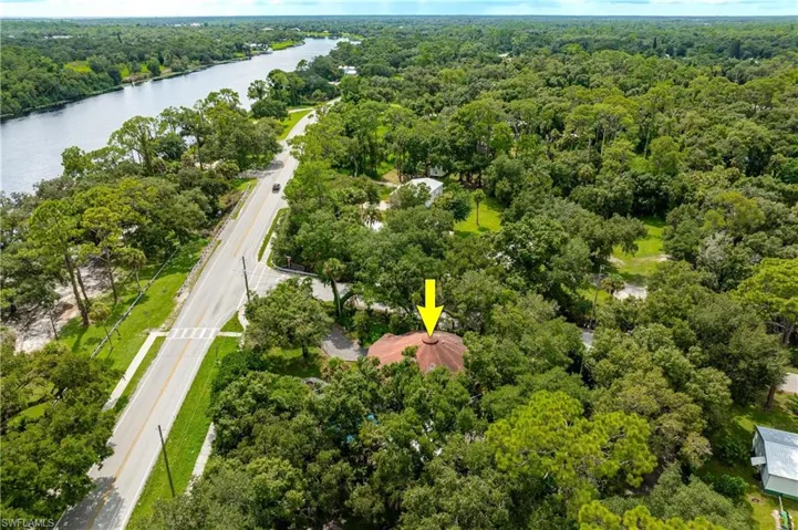 Birds eye view of property with a water view