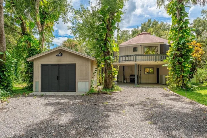 View of front of home with a balcony and a garage