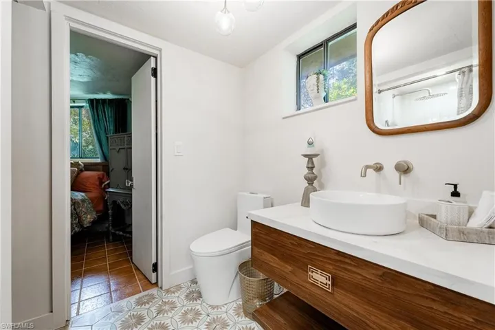 Bathroom with vanity, toilet, and tile patterned floors