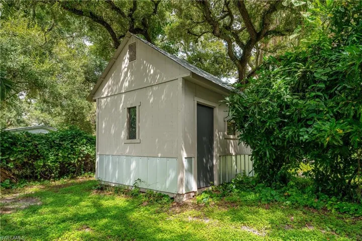 View of outdoor structure with a yard