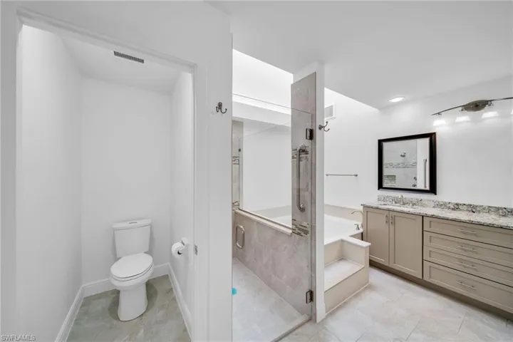 Full bathroom featuring tile patterned floors, independent shower and bath, toilet, and vanity