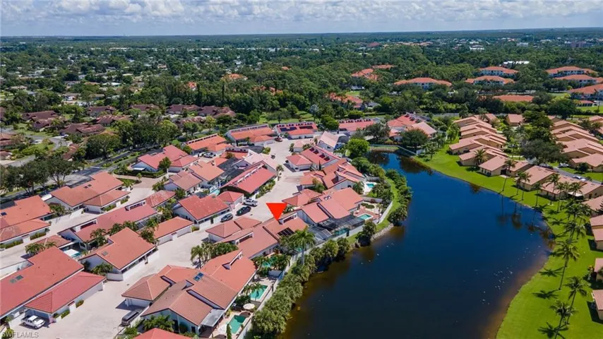 Birds eye view of property with a water view