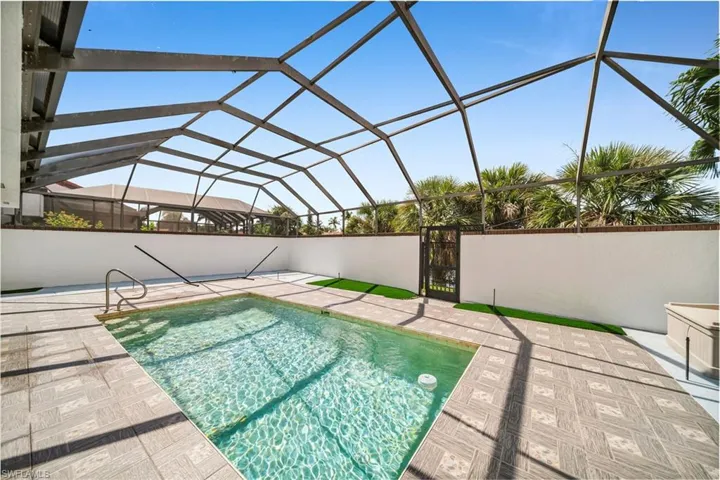 View of swimming pool with a lanai and a patio