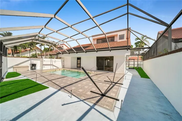 Rear view of house featuring a lanai and a patio area