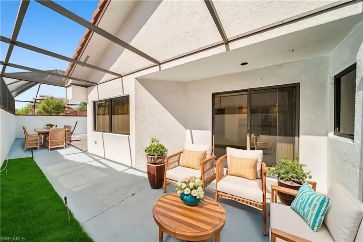 View of patio / terrace featuring glass enclosure and an outdoor hangout area