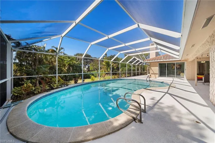 Beautiful swimming pool with a lanai and multiple sliding glass door entry's