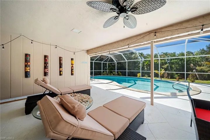 Swimming pool featuring a large covered lanai area, screened in pool and coveted southwestern exposure