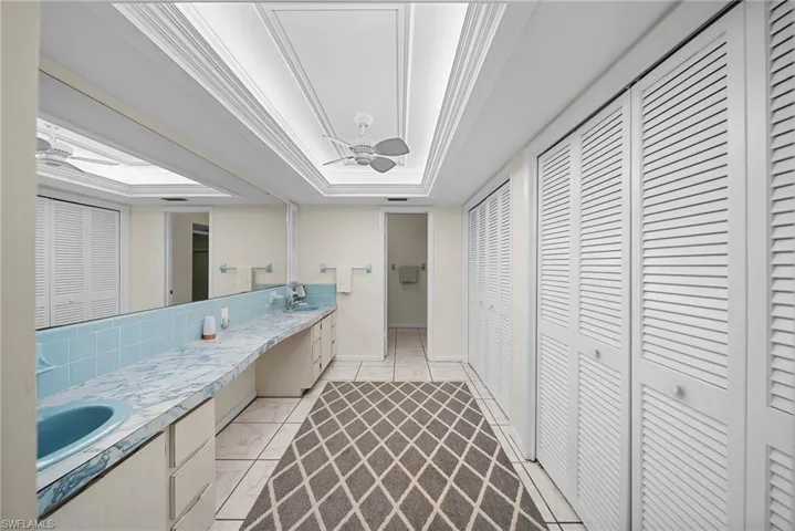 Full bathroom with a closet and double vanity