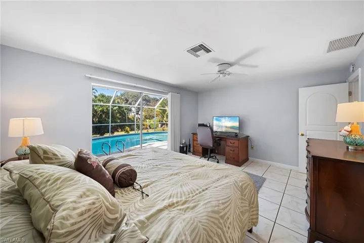 Master Bedroom featuring access to exterior, ceiling fan, and tile floors