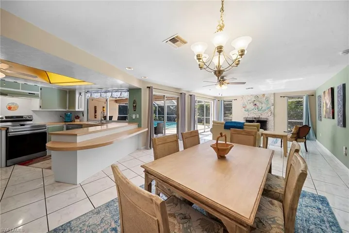 Dining space with a chandelier. Convenient access to kitchen