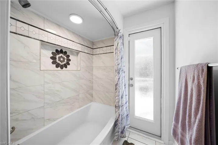 Bathroom with shower / bath combination and direct access to pool