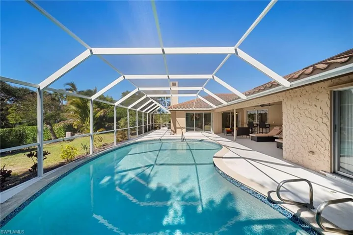 Private Swimming pool with screened enclosure, outdoor lounge area