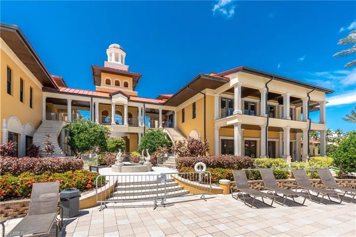 Back of house with stairway, stucco siding, a patio, and a balcony