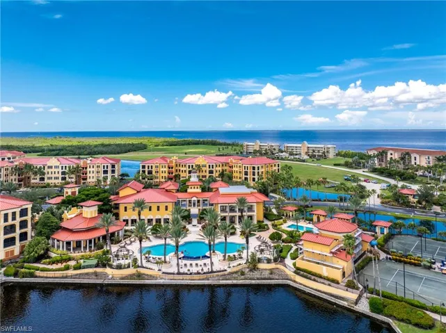 Drone / aerial view of a pool and a large body of water