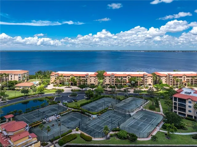 Drone / aerial view of a large body of water and apartment complex / building