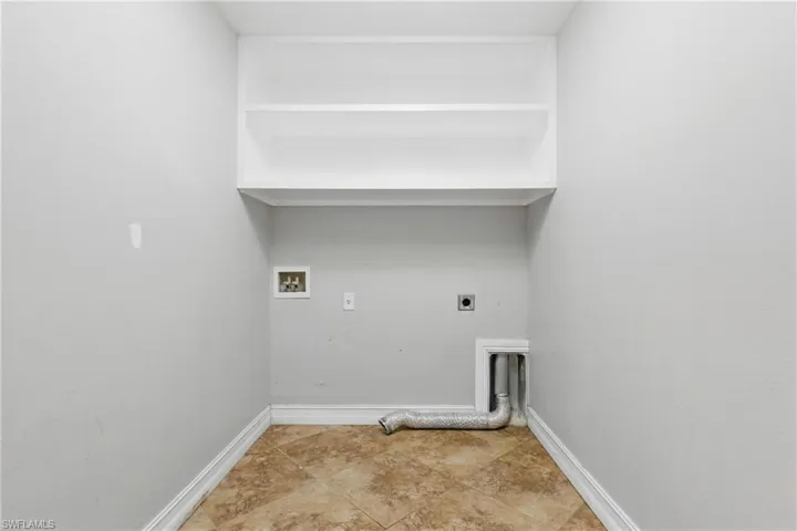 Laundry area featuring laundry area, washer hookup, baseboards, and hookup for an electric dryer