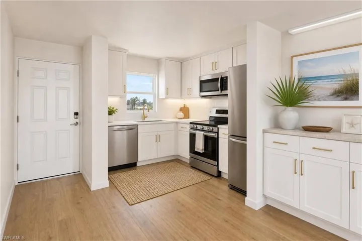 Staged View Of Front Door & Kitchen