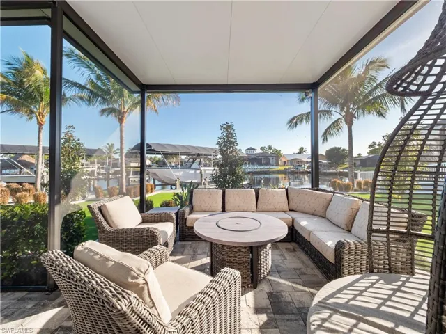 View of patio / terrace with a sunroom, an outdoor lounge area, a residential view, and a water view
