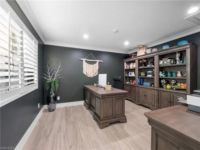 Office area with crown molding, light wood-style floors, and recessed lighting