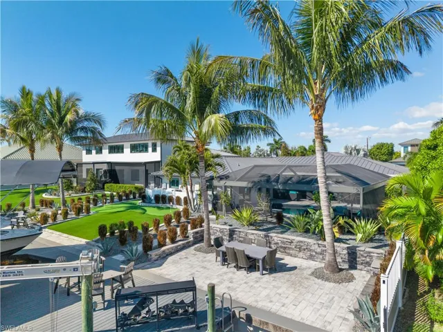 View of patio with a lanai and an outdoor pool