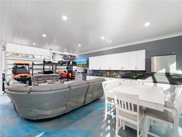 Living area featuring recessed lighting, wooden ceiling, and a garage