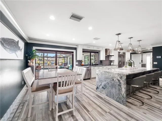 Dining space featuring crown molding, recessed lighting, and light wood finished floors