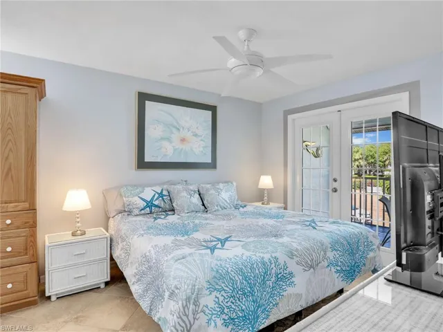 Bedroom featuring french doors, ceiling fan, and access to outside