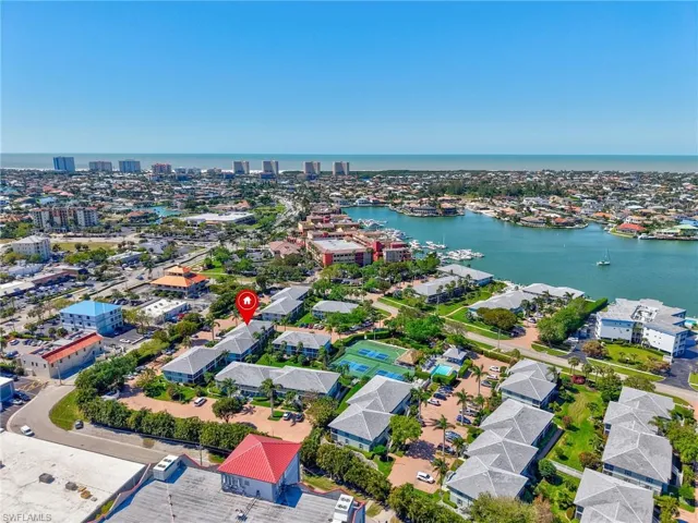 Birds eye view of property with a water view