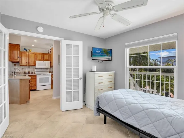 Bedroom with a ceiling fan and a sink