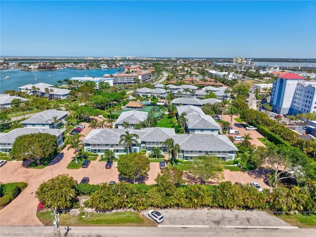 Birds eye view of property with a water view