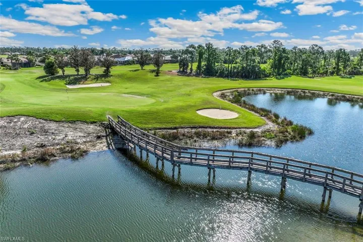 The property offers views of a golf course with green fairways, sand traps, and a water feature