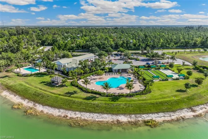 Exterior view of the property's recreational facilities, featuring two pools, a poolside cabana, and manicured green spaces
