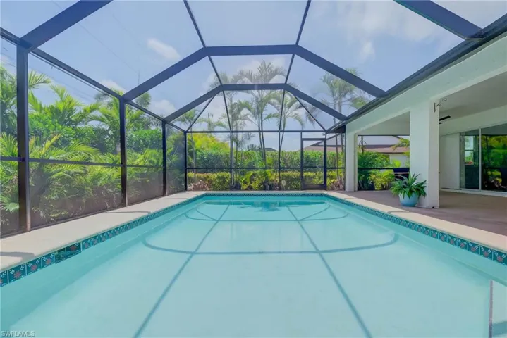 Outdoor pool with a patio area and a lanai