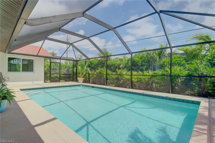 Swimming pool featuring a lanai and a patio area