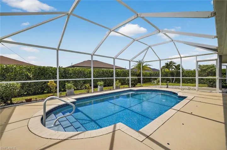 Resort-style solar-heated swimming pool with spacious paver patio and screened lanai — perfect for year-round outdoor living in Cape Coral, FL. Pool pump replaced 2025.