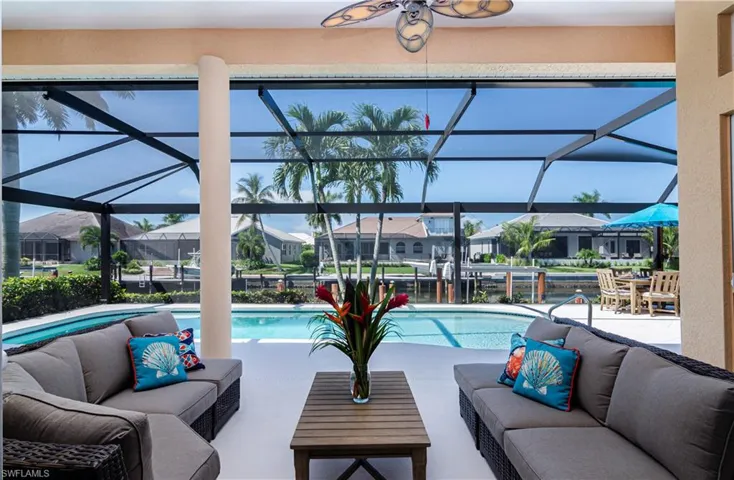 View of swimming pool featuring an outdoor living space, a lanai, a patio area, and ceiling fan