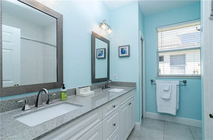 Bathroom with tile patterned flooring and vanity