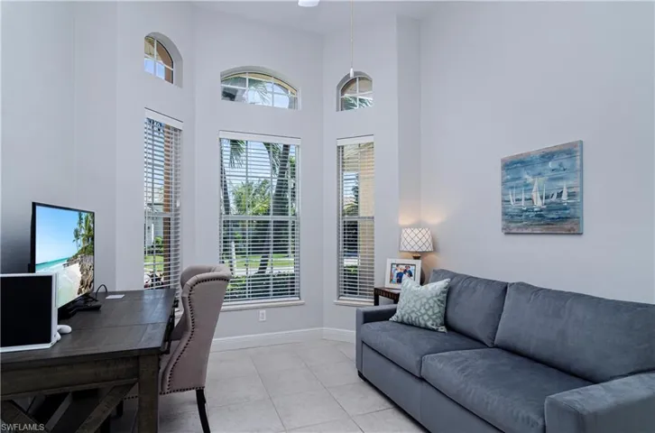 Tiled home office with a towering ceiling