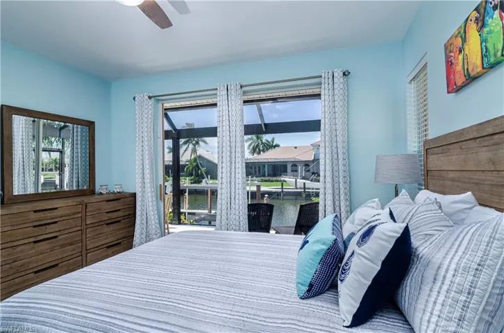 Bedroom with a water view and ceiling fan