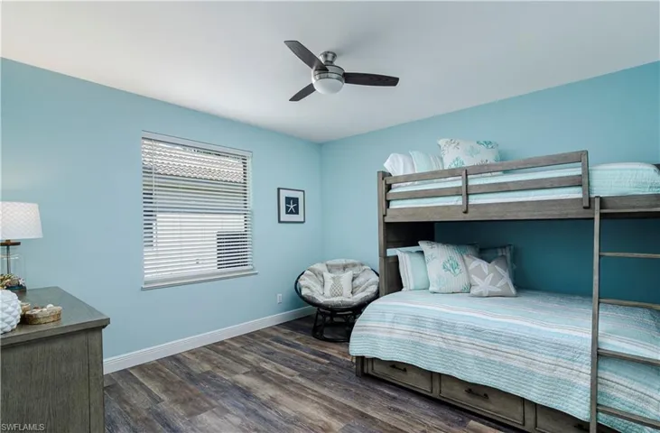 Bedroom with dark hardwood / wood-style flooring and ceiling fan