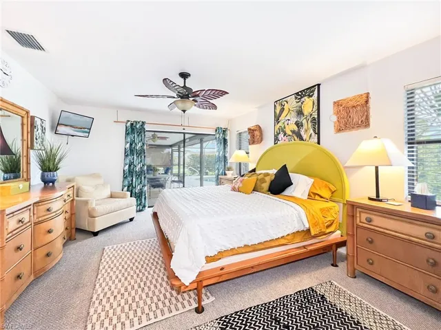 Bedroom with ceiling fan, access to outside, and light carpet