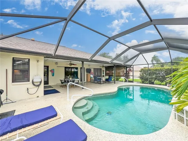 View of pool featuring a lanai, a patio, and ceiling fan