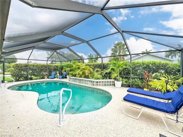 View of pool with a lanai and a patio