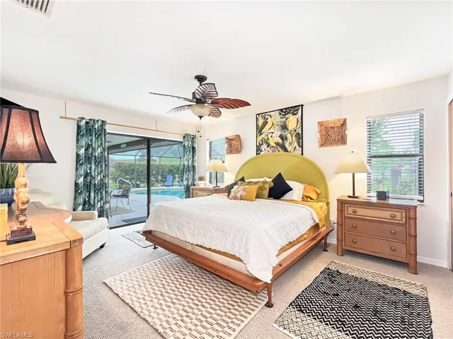 Bedroom with ceiling fan, access to outside, and light colored carpet
