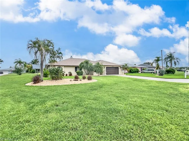 Single story home with a front lawn and a garage