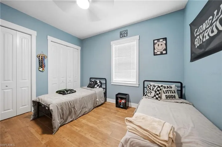 Room featuring light blue walls and wood-finish flooring
